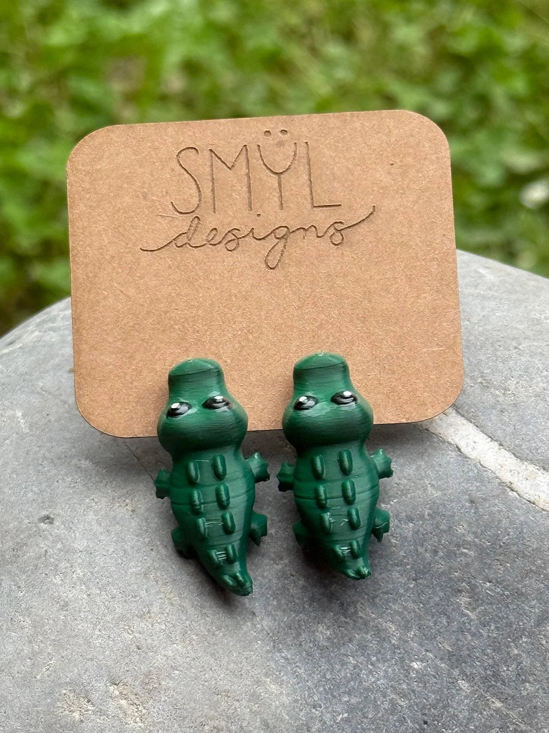 Green 3D-printed chomping alligator earrings by SMYL Designs
