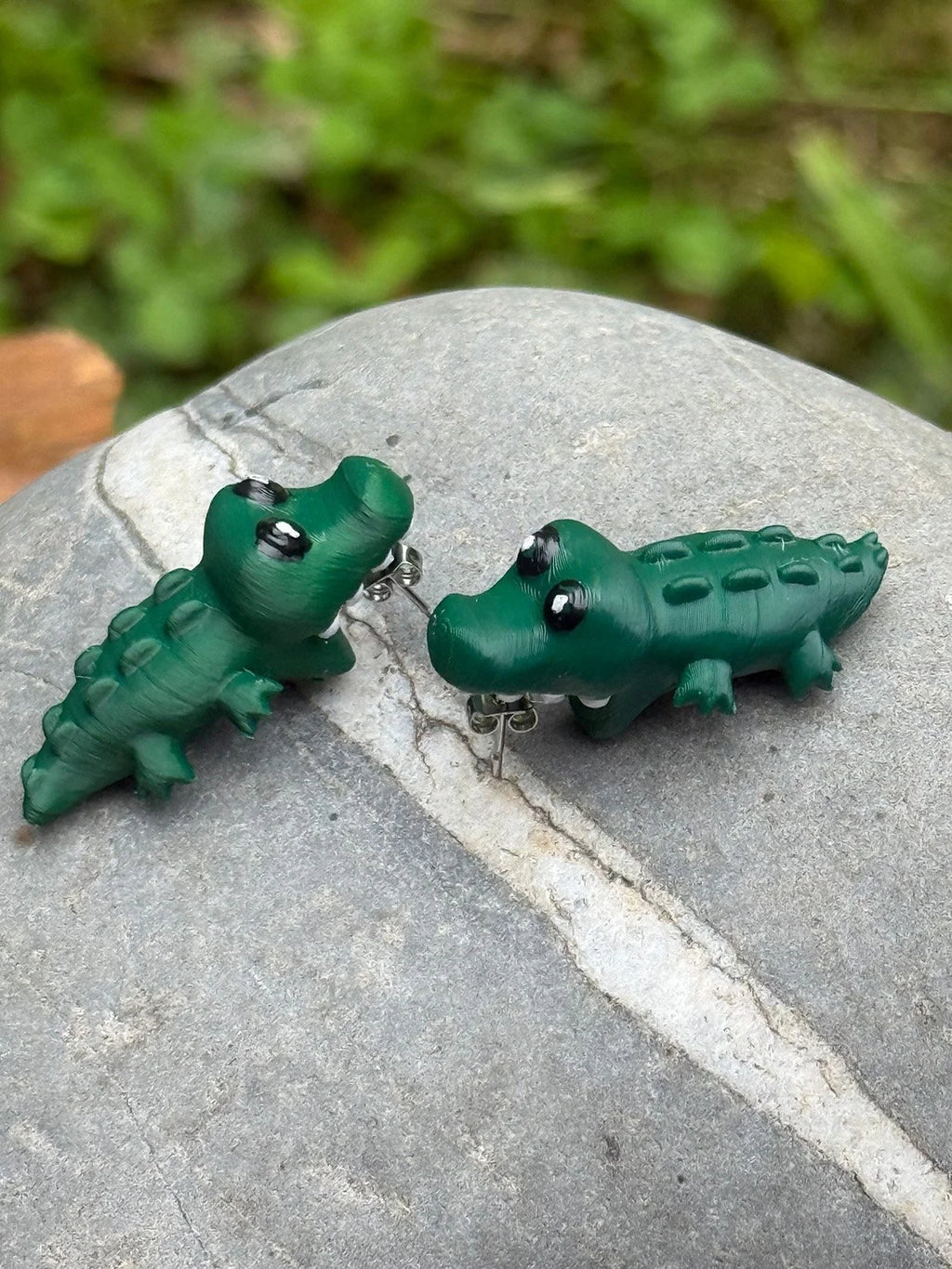 Close-up detail of chomping alligator earrings