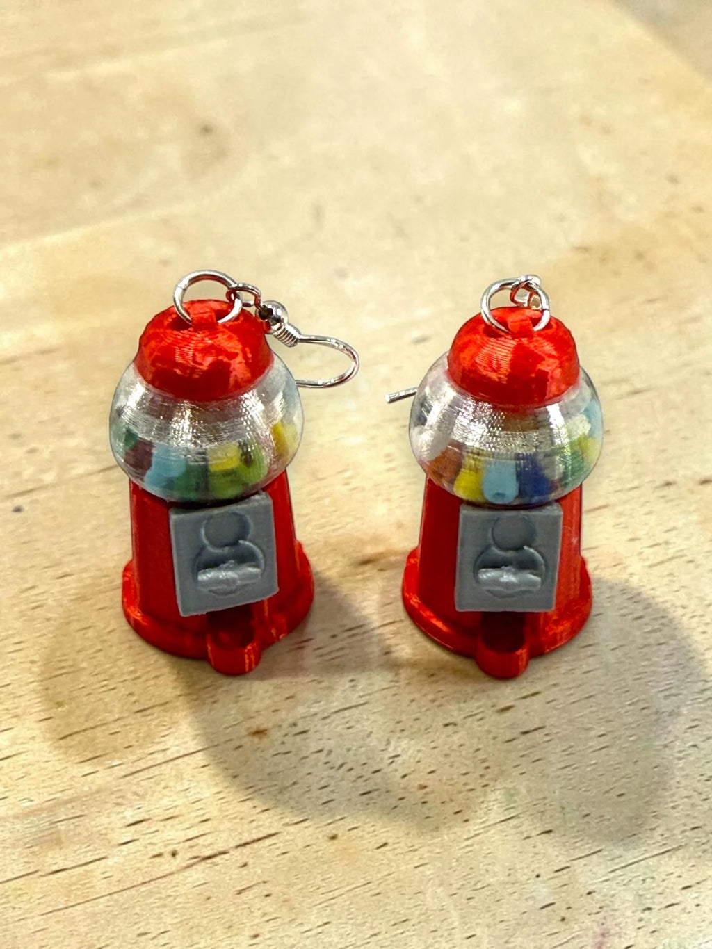 Scale and detail view of red gumball machine earrings
