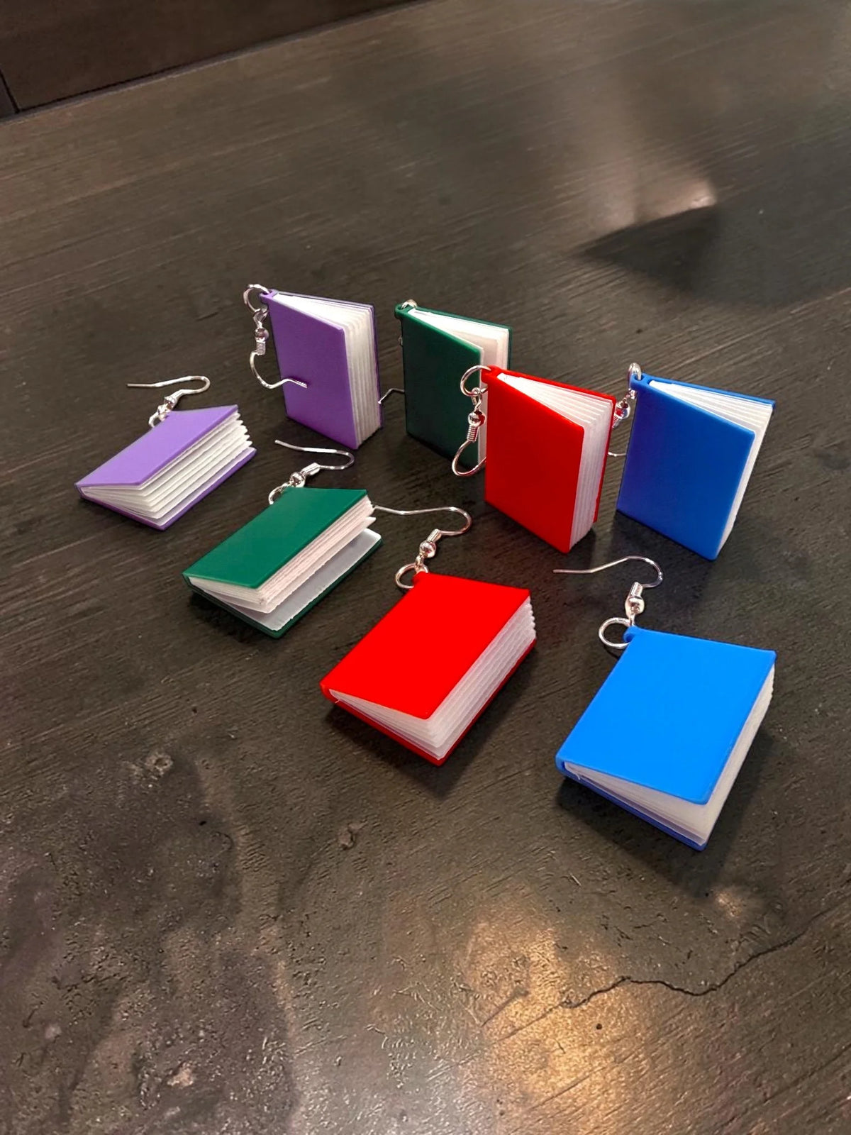 Colorful 3D-printed book earrings with flip pages
