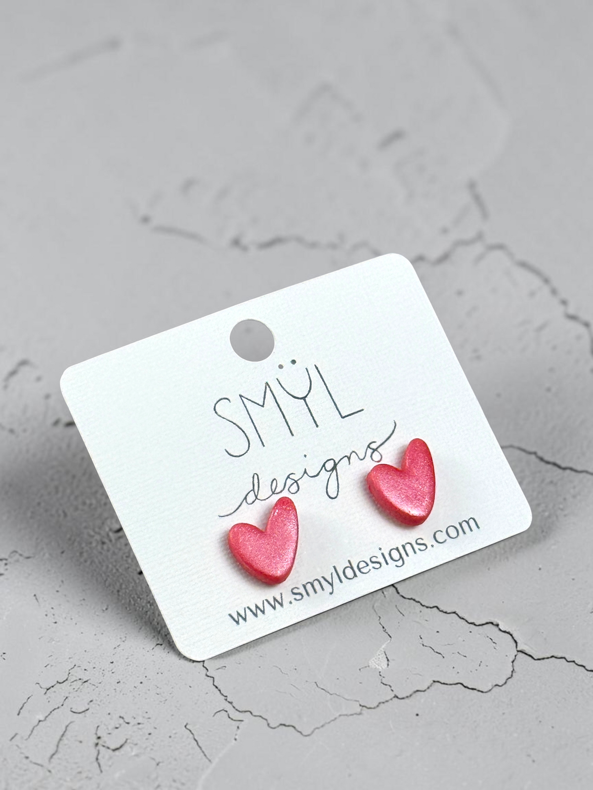 Metallic pink asymmetrical heart stud earrings by SMYL Designs