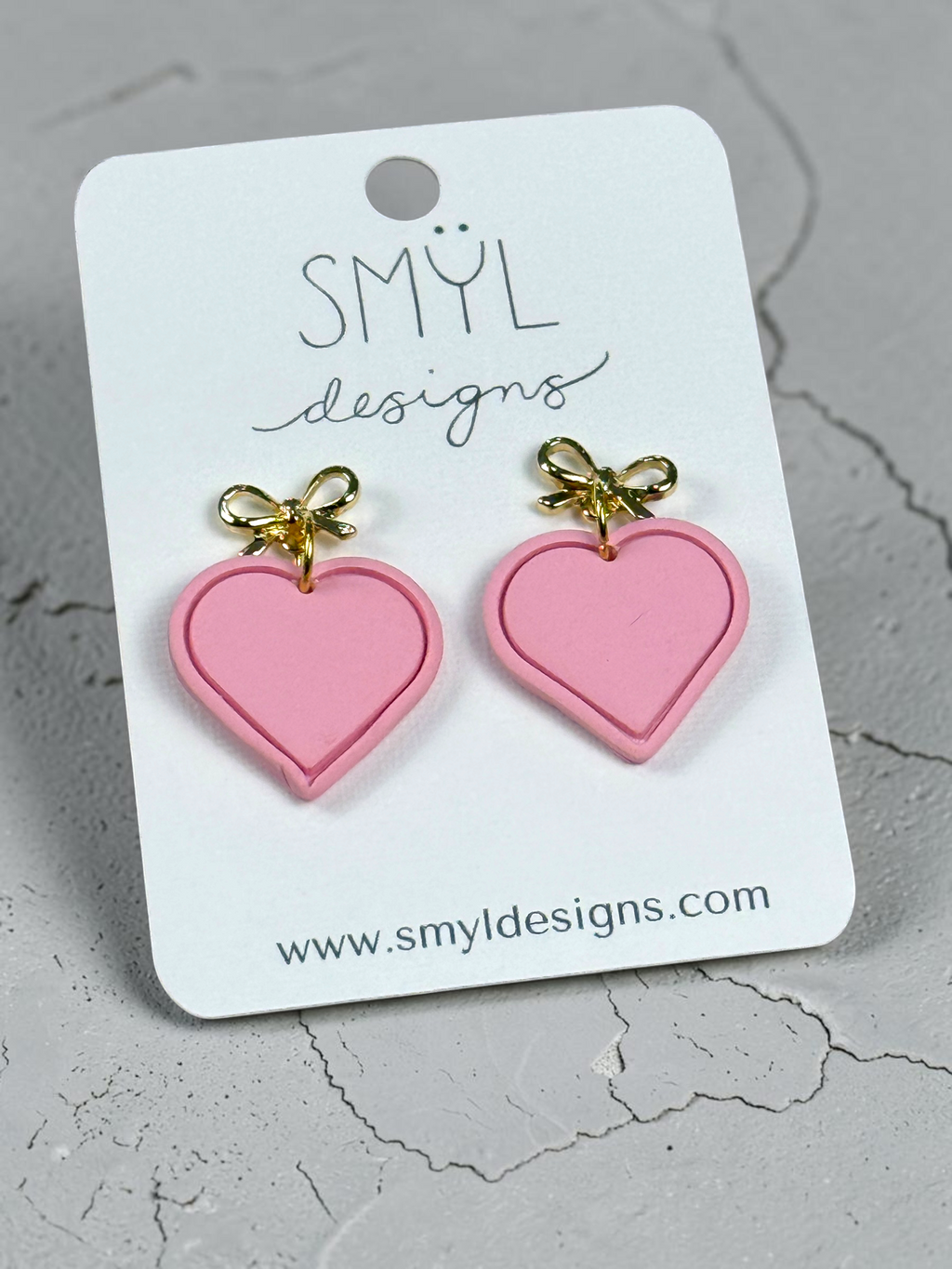 Pink single-heart dangle earrings with gold bow studs