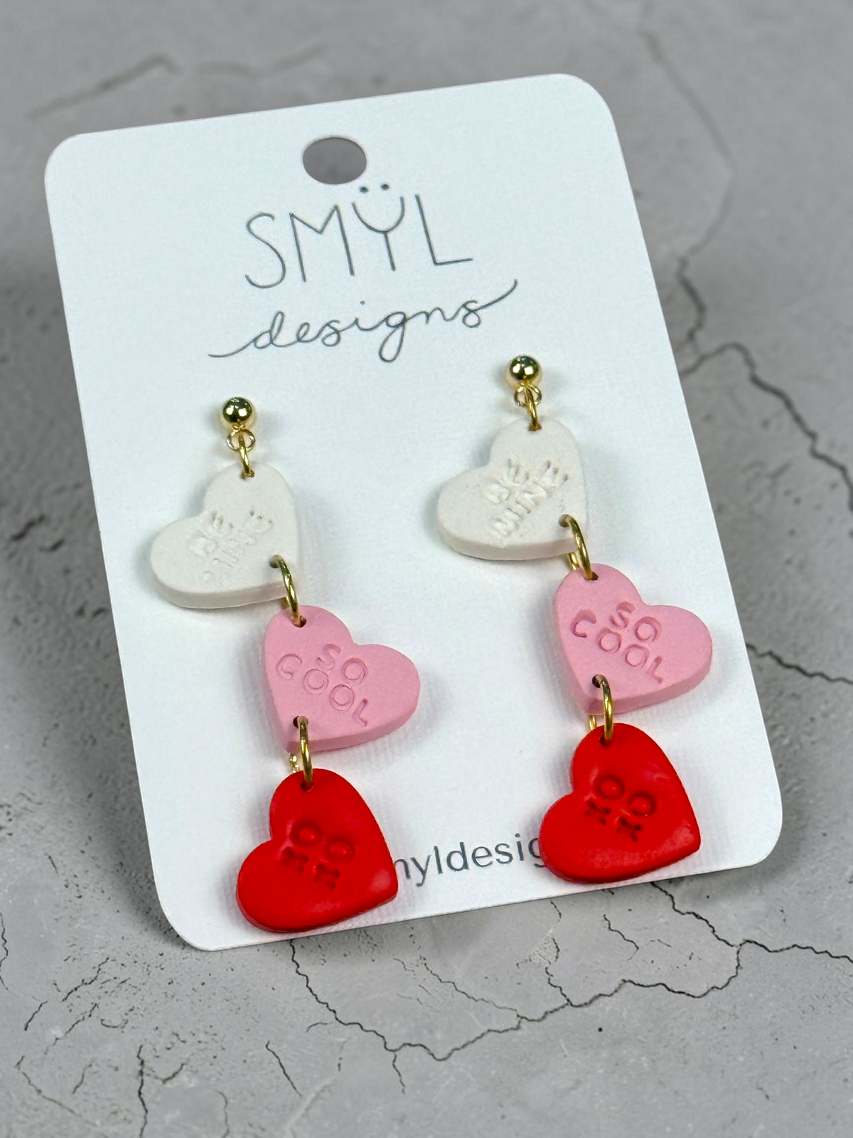White, pink, and red conversation-heart dangle earrings