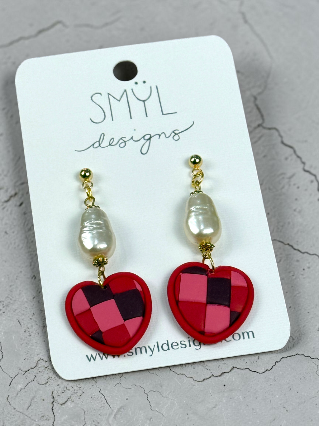 Angled view of patchwork heart dangles with pearl accents