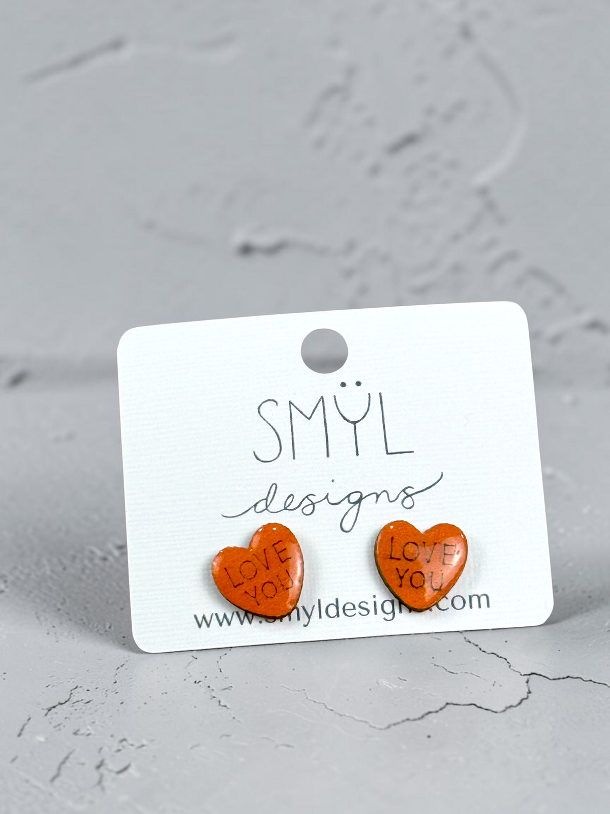 Orange conversation-heart stud earrings, alternate message