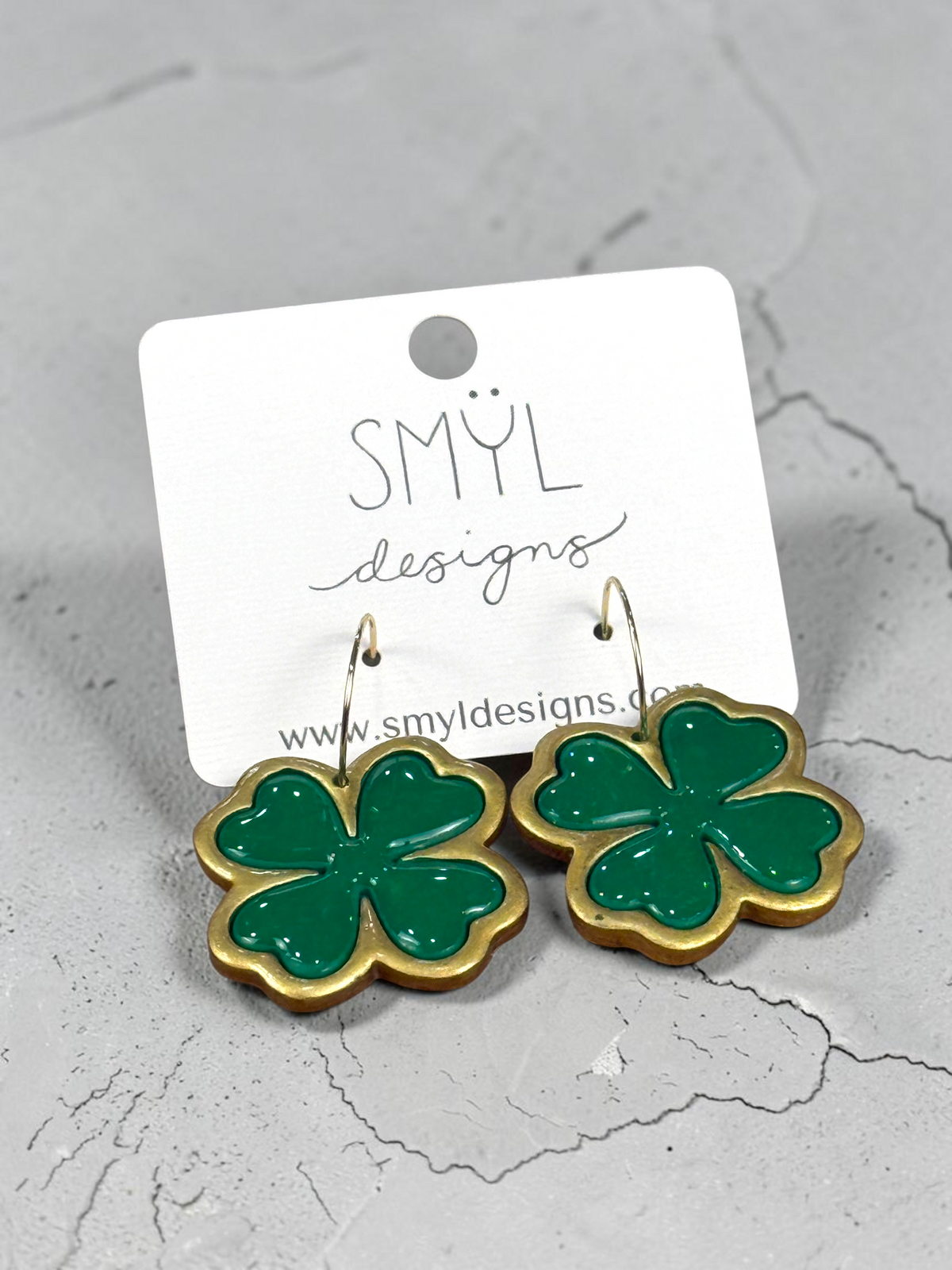 Large green four-leaf clover hoop earrings with gold-tone borders by SMYL Designs