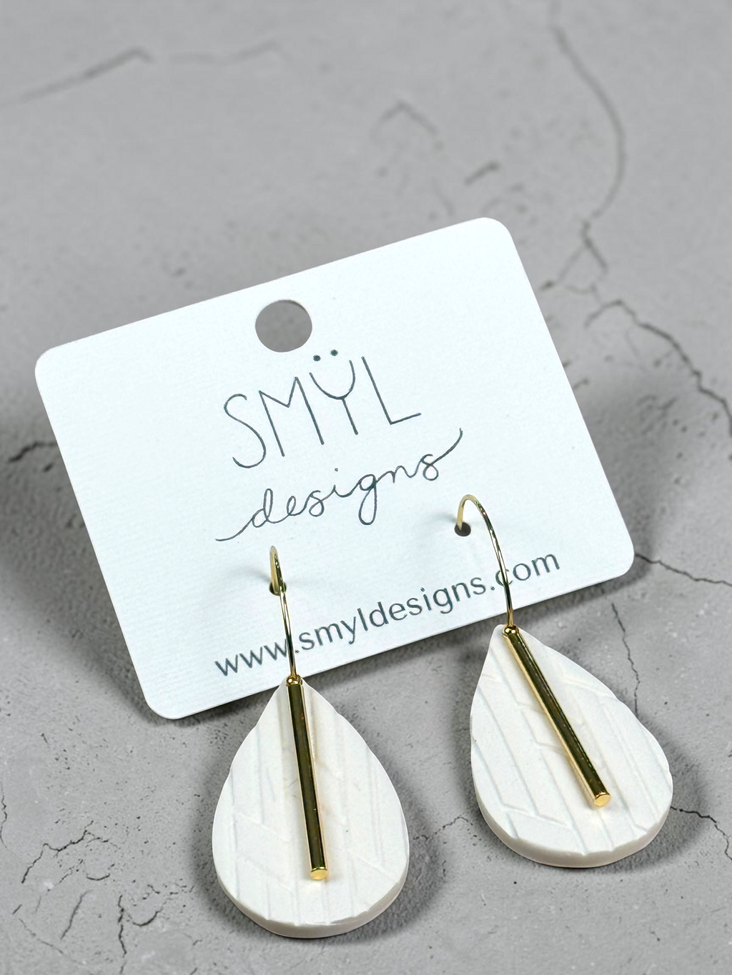 White textured teardrop hoop dangles, alternate view
