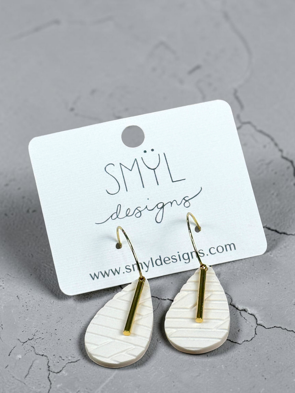 White textured diamond hoop dangles with gold accent bars