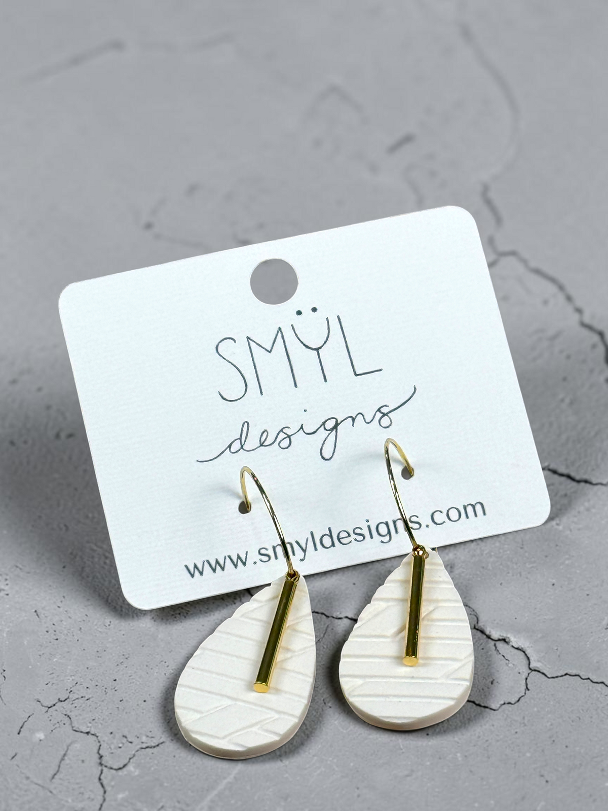 White textured diamond hoop dangles with gold accent bars