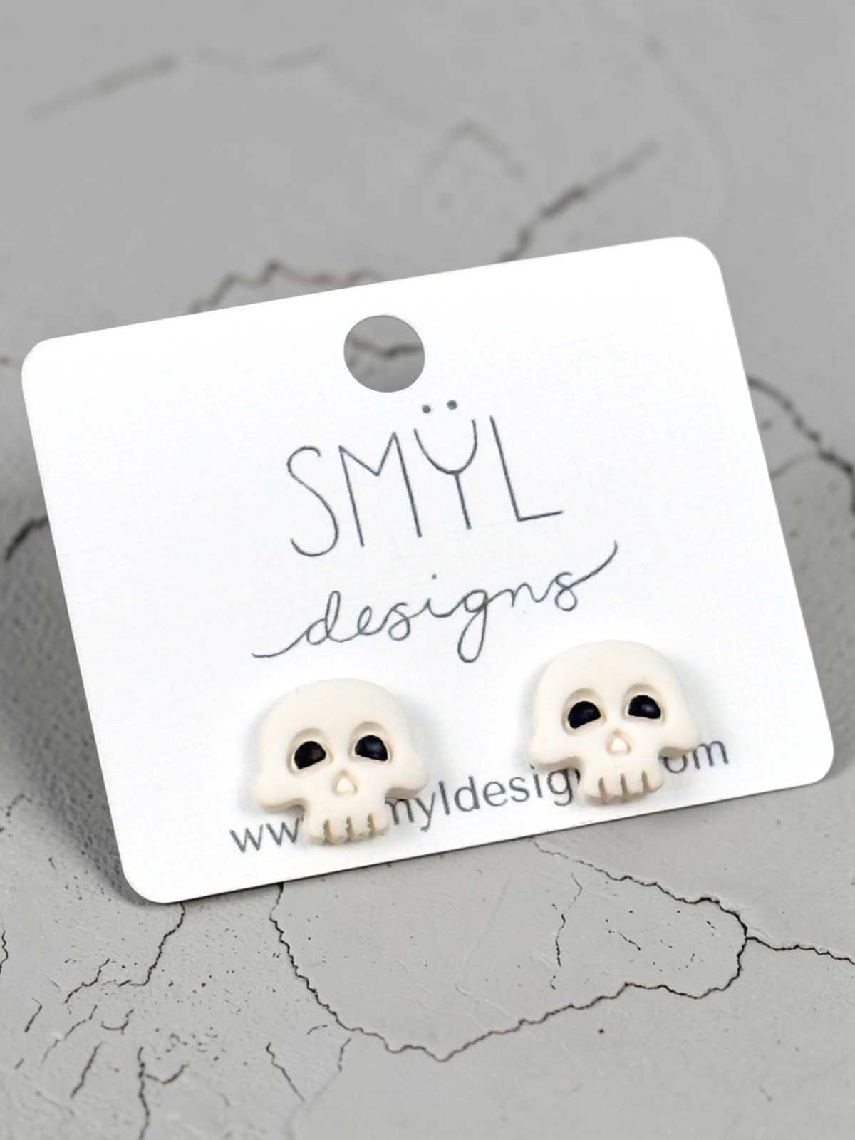 White skull stud earrings with black details by SMYL Designs