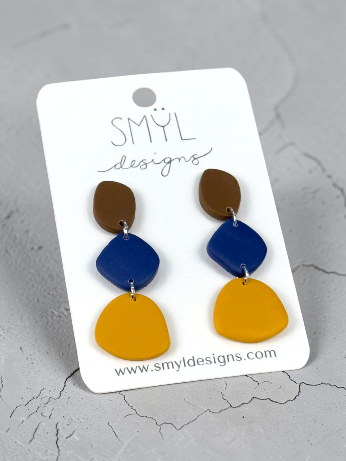 Brown, navy, and mustard geometric polymer clay dangle earrings with silver-tone connectors by SMYL Designs