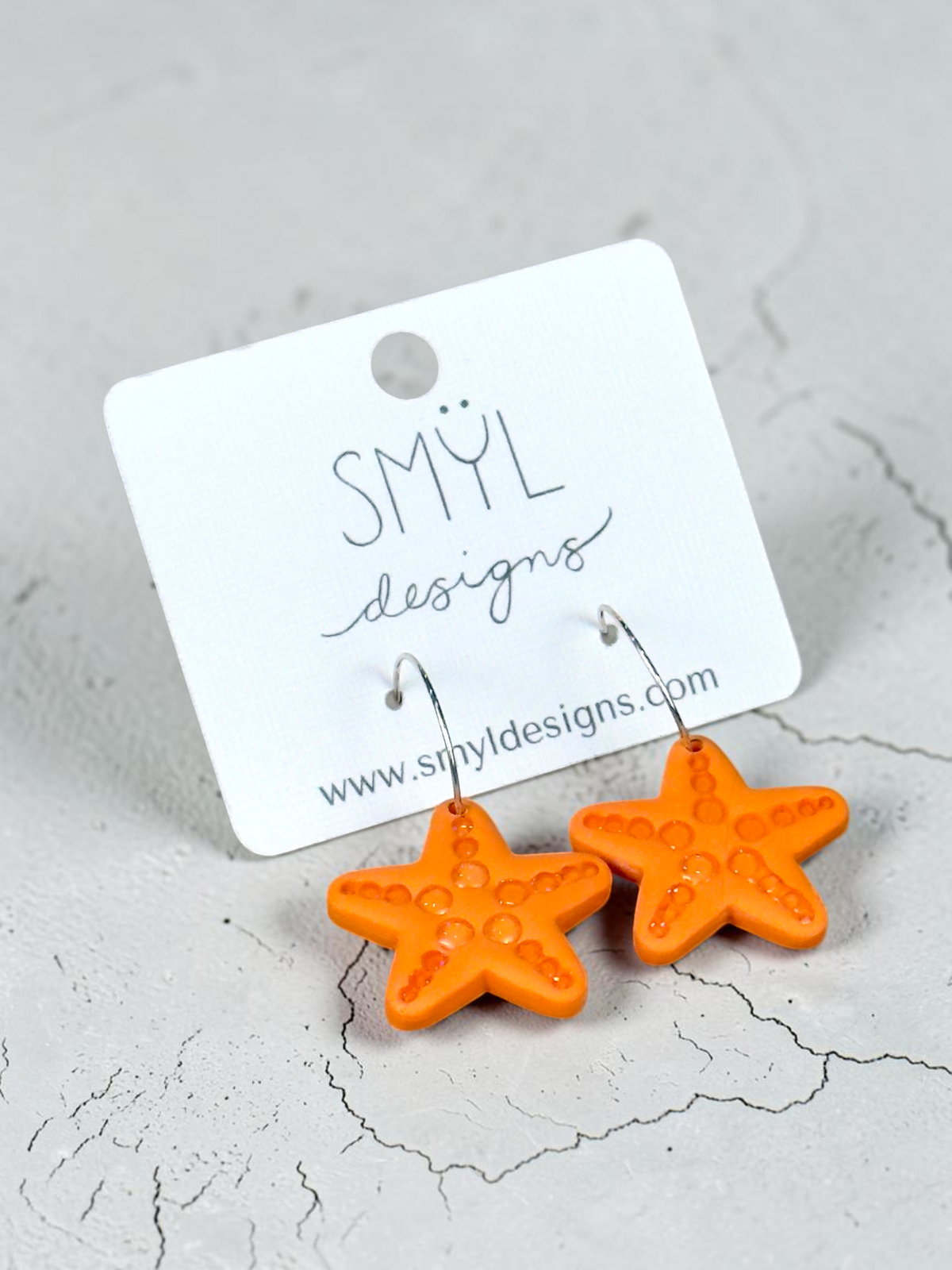 Orange polymer clay starfish dangle earrings with silver-tone ear wires by SMYL Designs