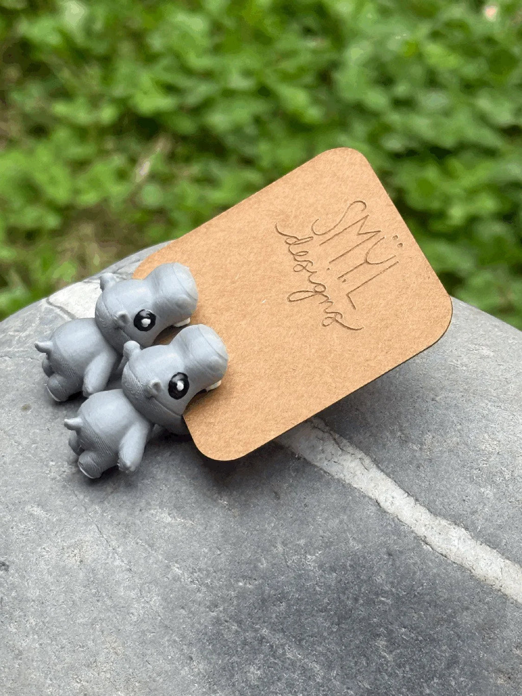 Side view of purple chomping hippo earrings