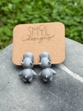 Purple 3D-printed chomping hippo earrings by SMYL Designs