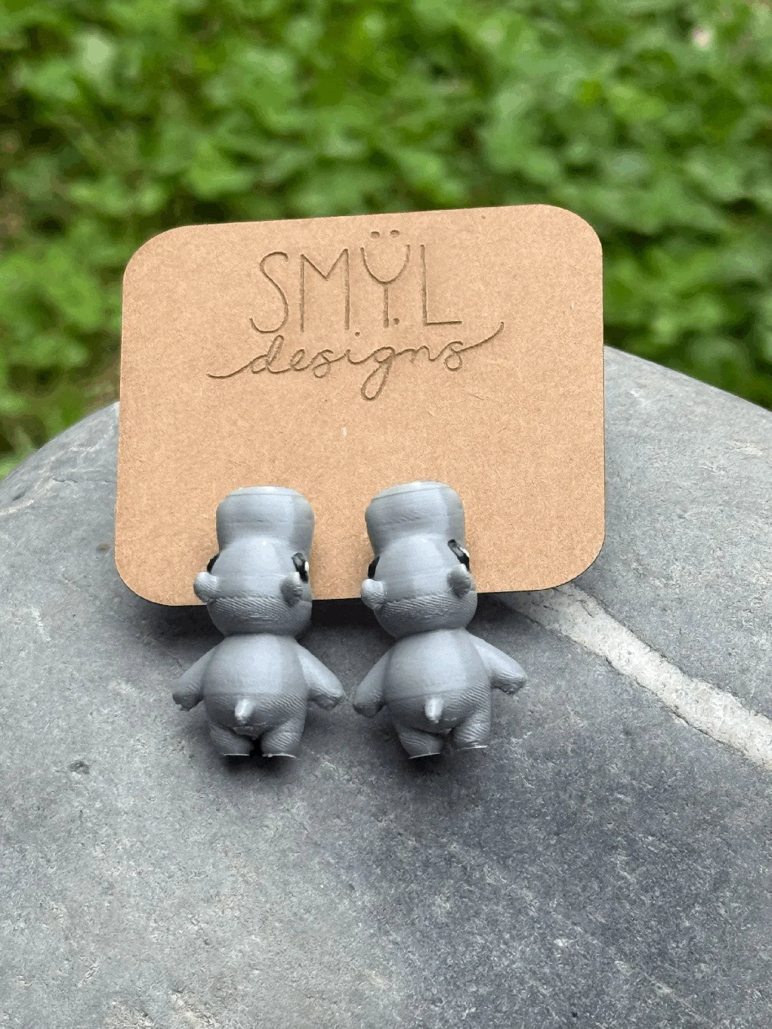 Purple 3D-printed chomping hippo earrings by SMYL Designs